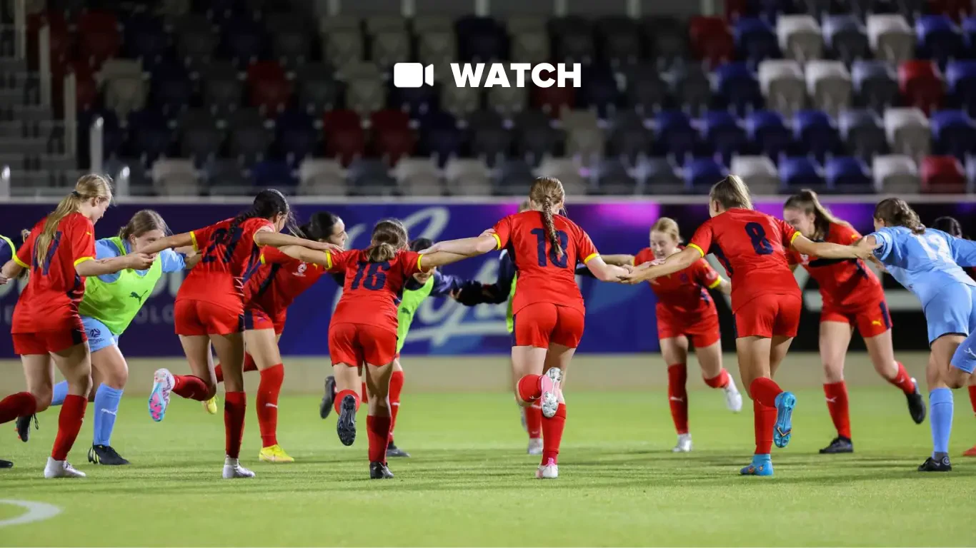 Female players from Football South Australia celebrate a team win.