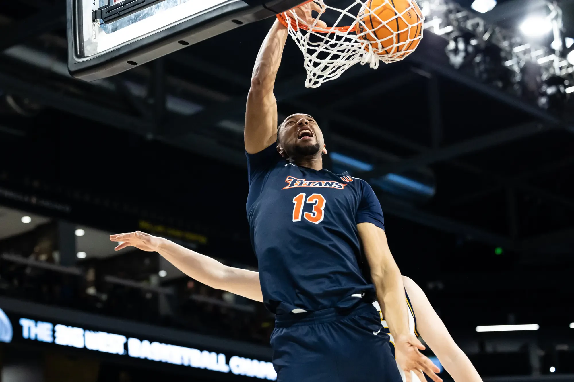 Photo of California State University - Fullerton basketball player scoring a goal.