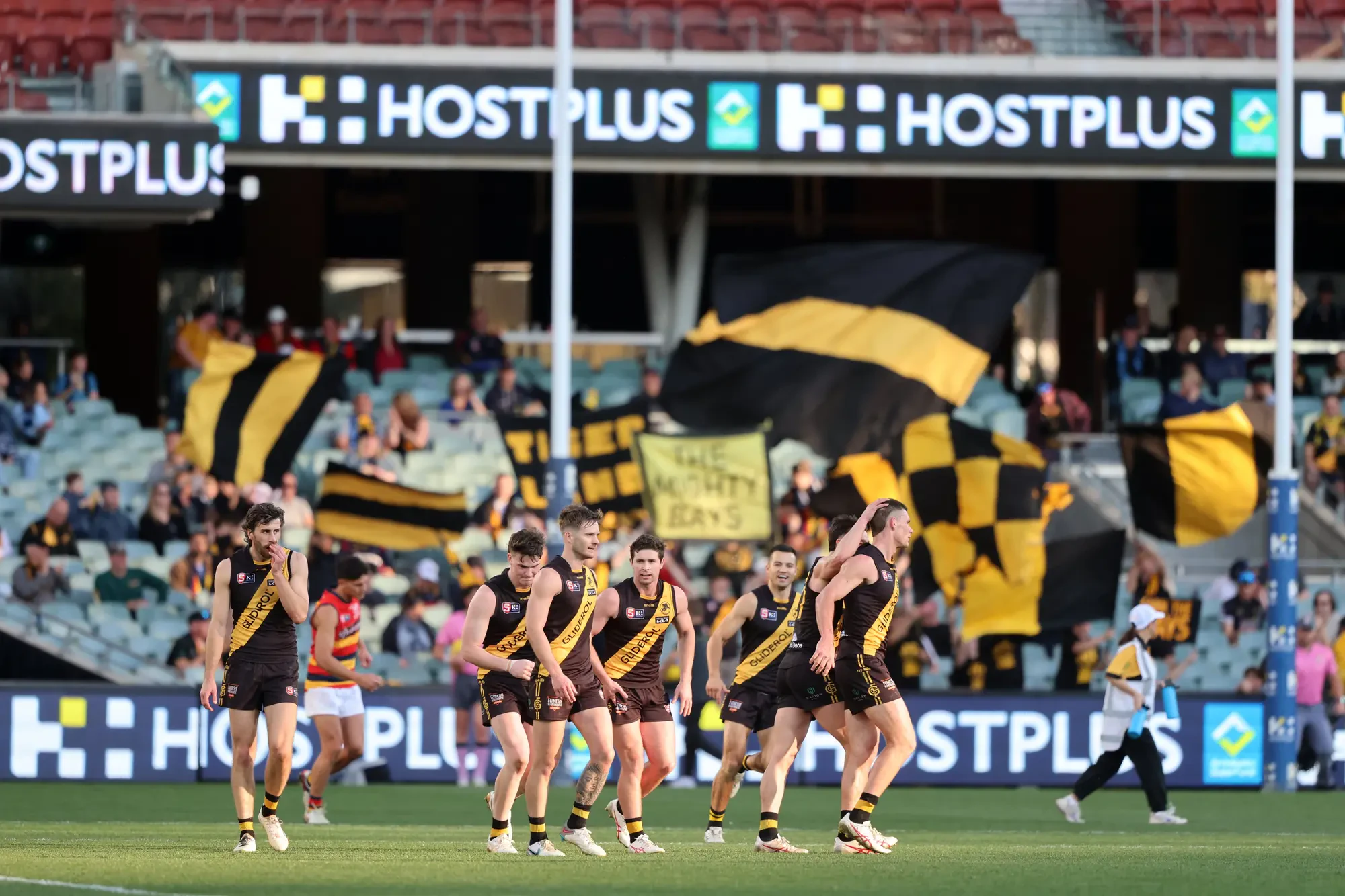 Photo of Glenelg Football Club players celebrating a goal.